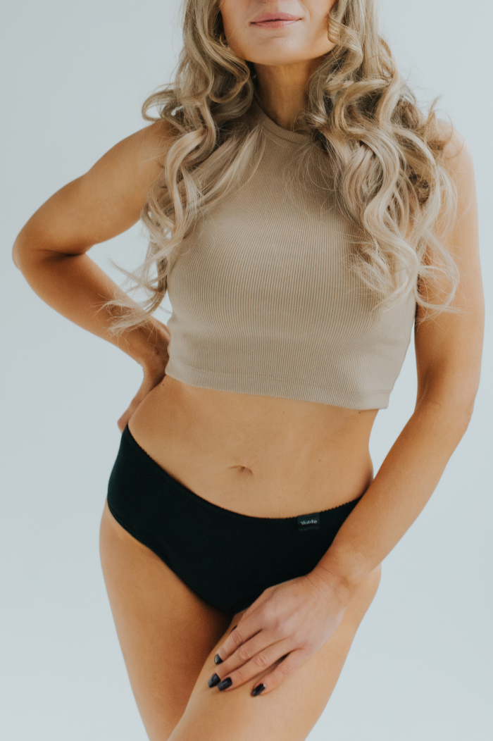 Model showcasing the new collection of period panties made from soft, breathable cotton. Stylish and eco-friendly design for comfortable menstrual protection.