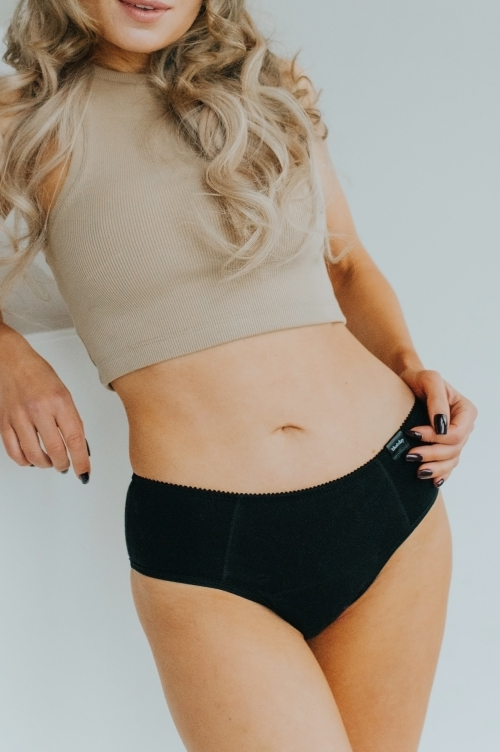 Model showcasing the new collection of period panties made from soft, breathable cotton. Stylish and eco-friendly design for comfortable menstrual protection.